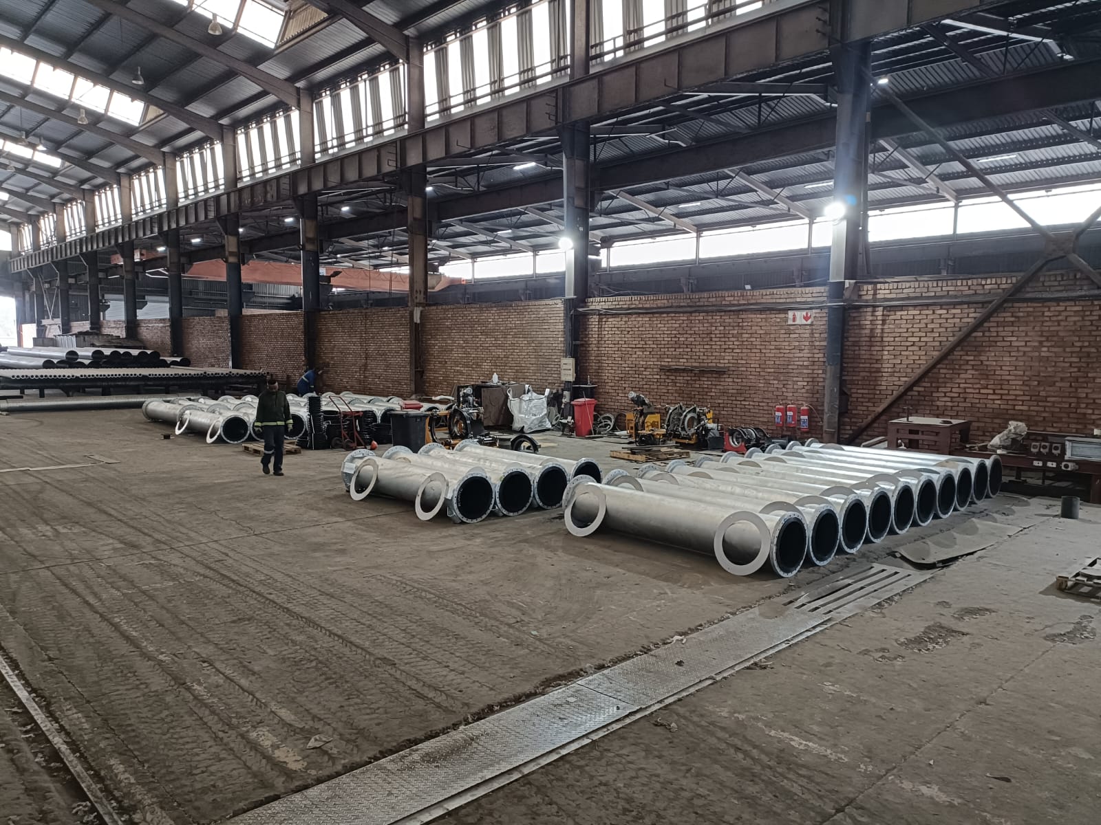 Wetpipe steel fabrication workshop with flanged pipe spools staged for coating and dispatch