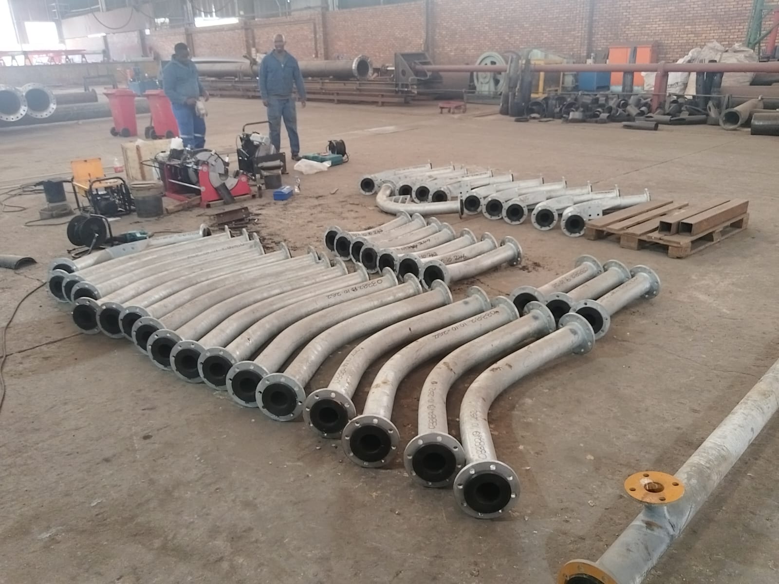 Batch of lined flanged steel pipe bends fabricated in the Wetpipe workshop