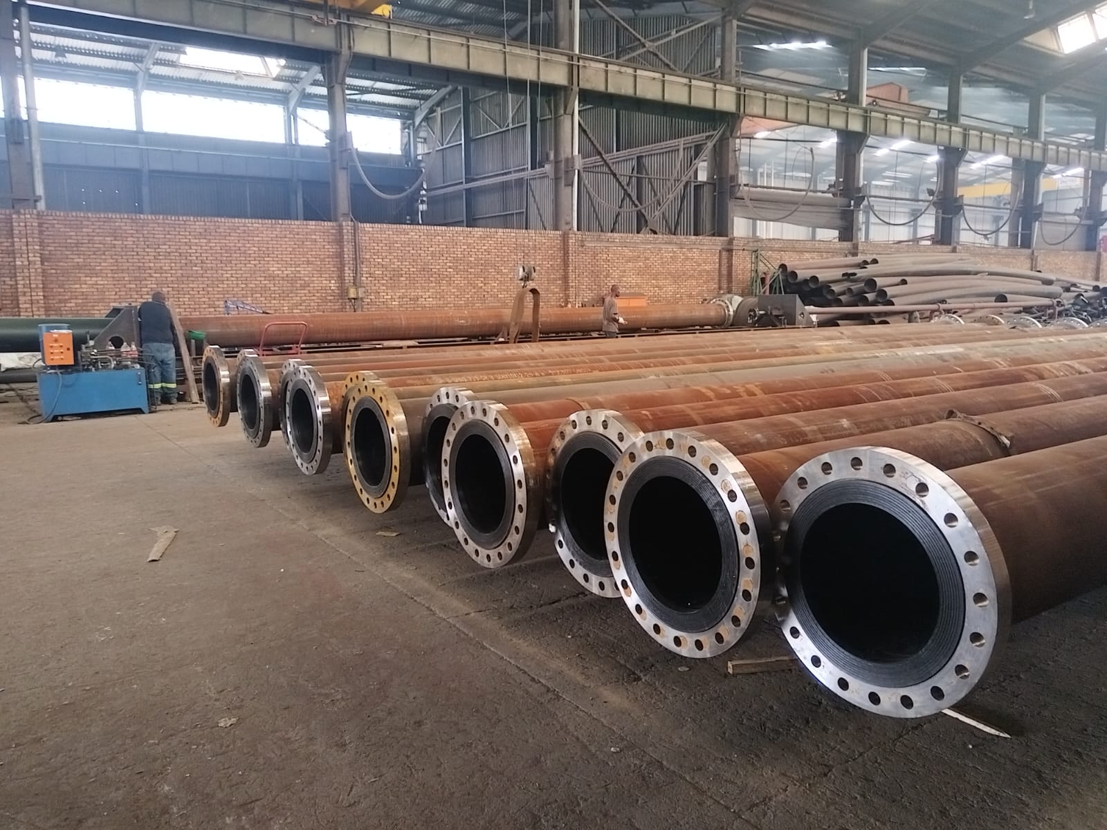 Lined carbon steel pipes with welded flanges on the Wetpipe fabrication workshop floor