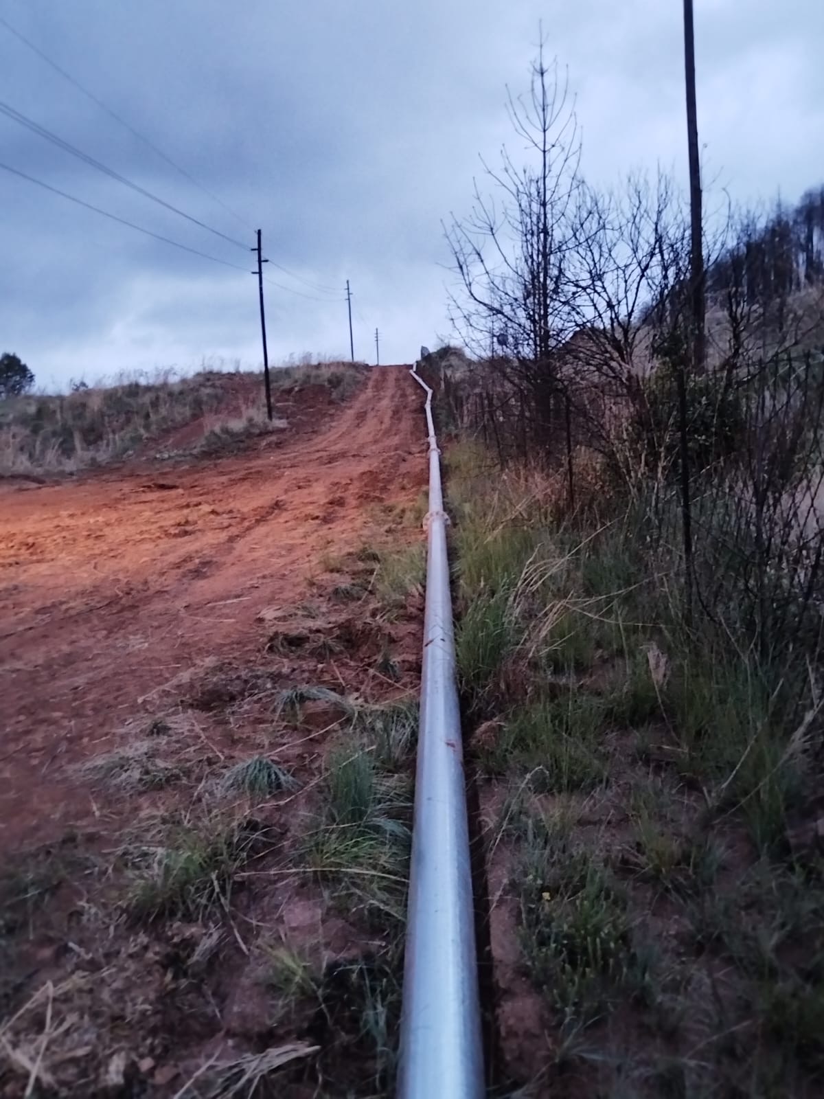 Overland slurry pipeline following a hillside access road